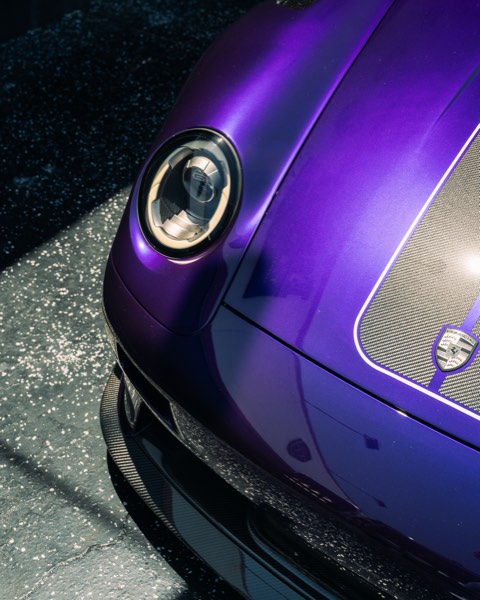 Headlight and hood detail with Porsche crest
